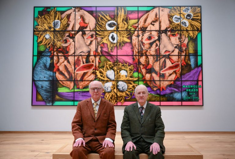 Gilbert and George: Gilbert and George pose together in front of an artwork entitled Magnolia Heads 2019, during a photocall at the opening of the Gilbert & George Centre in east London on March 24, 2023. (Photo by Daniel LEAL / AFP) via Getty Images). Artnet.
