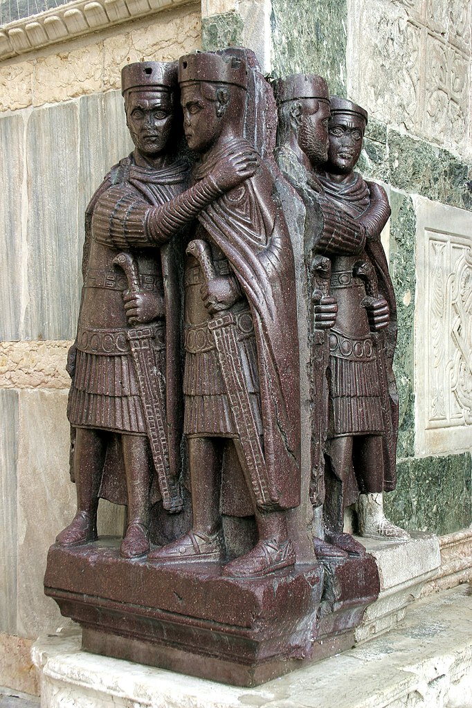 red porphyry: Photograph of The Four Tetrarchs, San Marco Square, Venice, Italy. Photograph by Rudolphous via Wikimedia Commons (CC-BY-SA-2.0).
