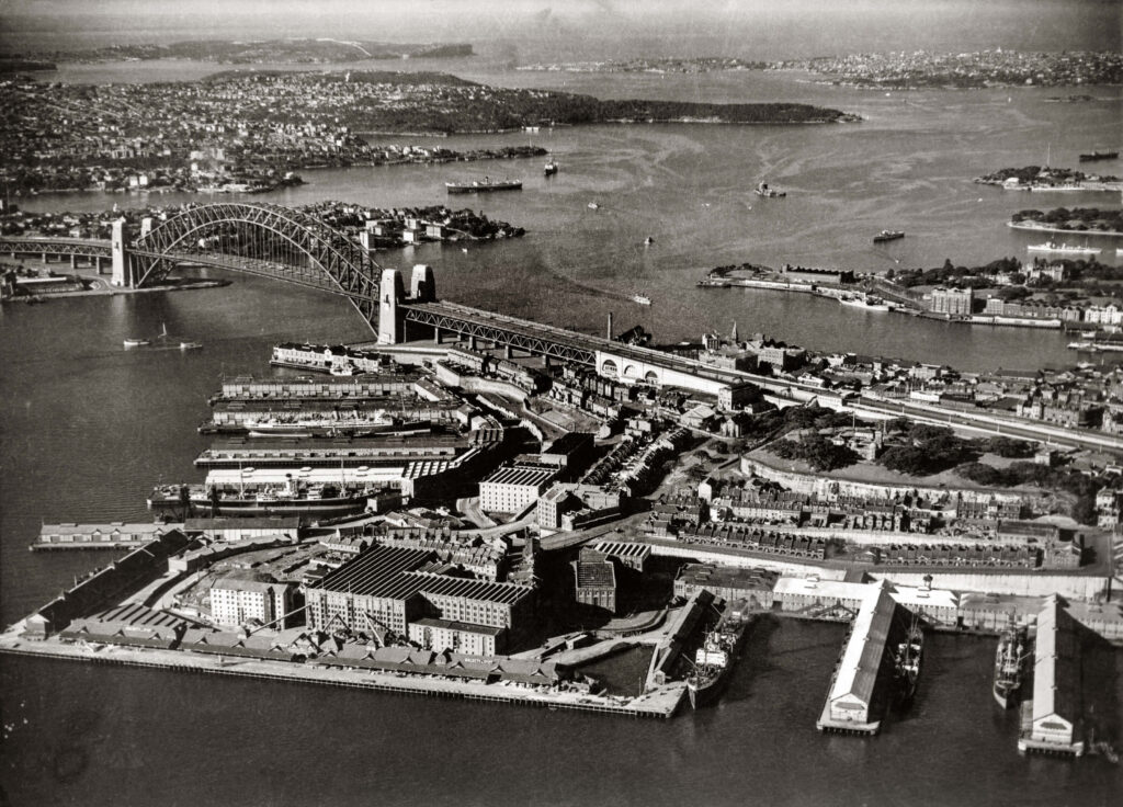 Sydney Opera House: Aerial view of Sydney Harbour from above Millers Point and Walsh Bay, 1950s. Archives of the City of Sydney.
