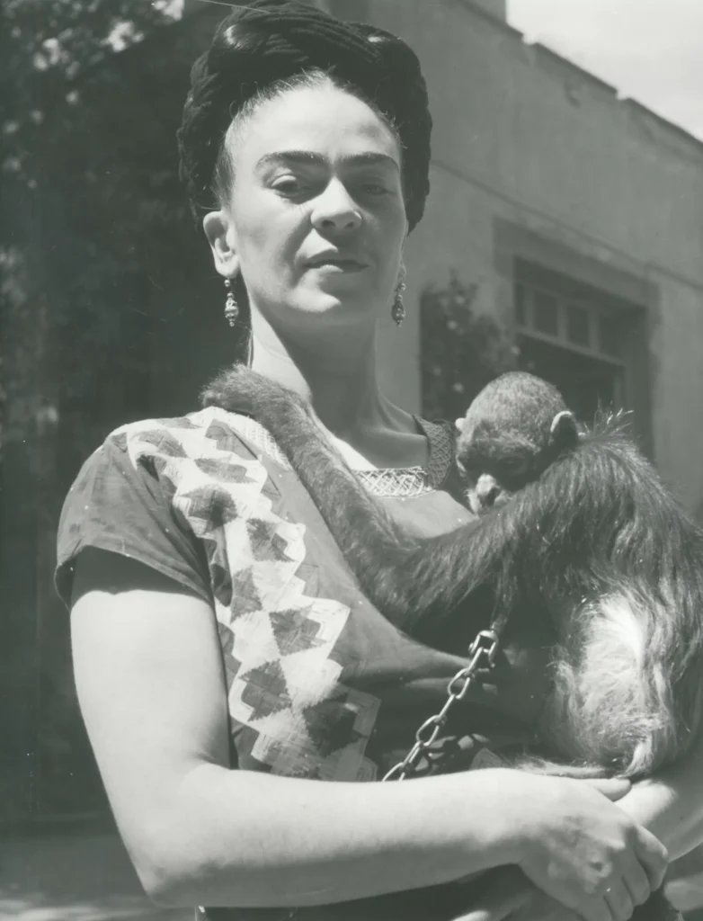 Frida Kahlo Self-Portrait with Thorn Necklace and Hummingbird: Fritz Henle, Frida in Front of Studio with Monkey, Coyoacan, 1946, Bentley Gallery
