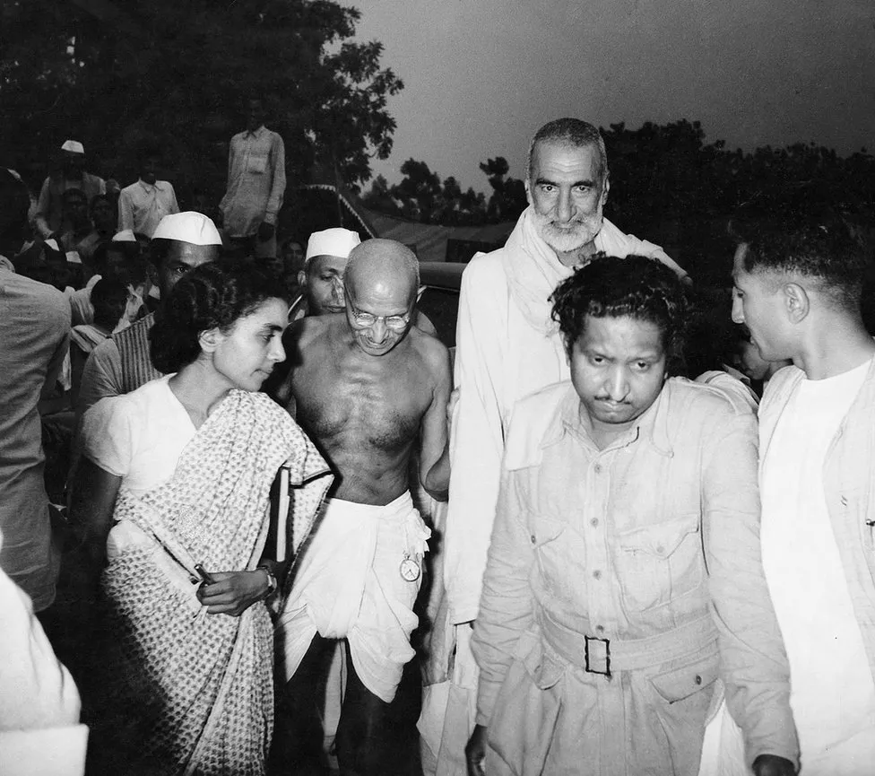 Homai Vyarawalla: Homai Vyarawalla, Mahatma Gandhi (left), and independence leader Khan Abdul Ghafar Khan (right) arrive at a meeting where it was decided to partition the country, The Alkazi Foundation for the Arts, Delhi, India. 
 

