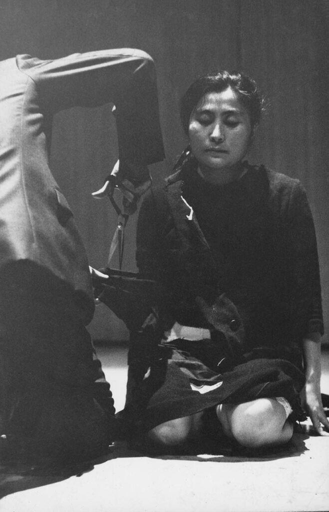 yoko ono exhibition: Yoko Ono, Cut Piece, 1964, photographed 11 August 1964, printed 2024. Performed by Yoko Ono in Yoko Ono Farewell Concert: Strip Tease Show, Sogetsu Art Center, Tokyo, Japan. Courtesy the artist © Yoko Ono Photograph by Minoru Hirata. Tate Modern.

