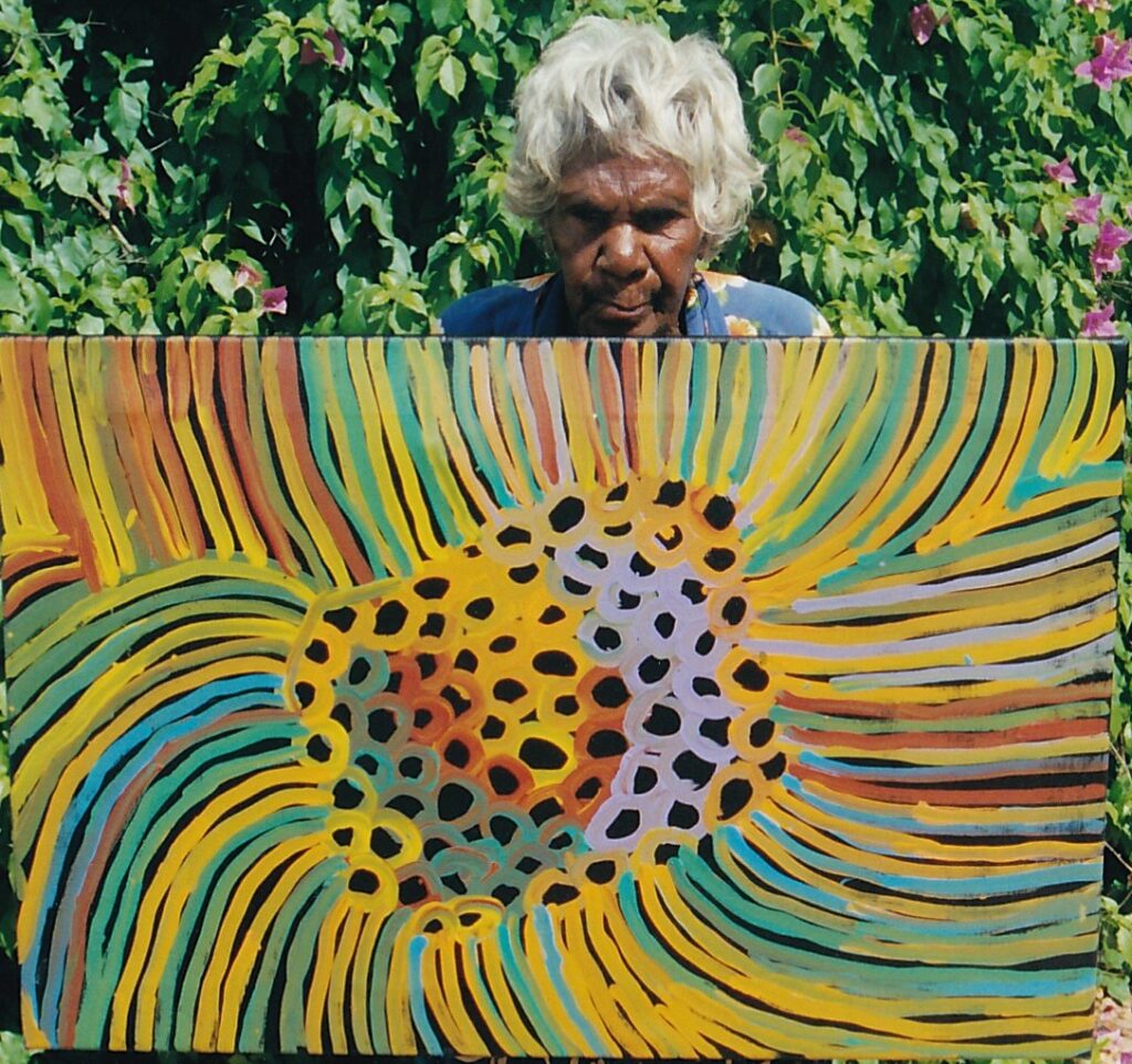 Minnie Pwerle: Minnie Pwerle with one of her paintings. Aboriginal Art.
