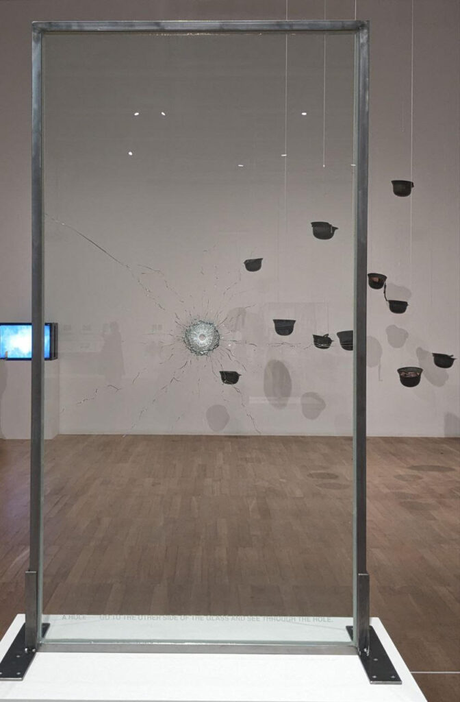 yoko ono exhibition: Exhibition view, foreground: Yoko Ono, A HOLE, 2009; background: Yoko Ono, Helmets (Pieces of Sky), 2001, Tate Modern, London, UK. Photograph by Barbara Bravi.
