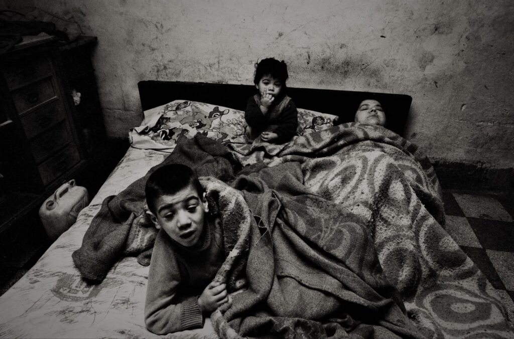 Letizia Battaglia: Letizia Battaglia, This woman and her children are always in bed; there’s neither electricity nor water in the house, Palermo, 1978, Letizia Battaglia Archive. iItaly.
