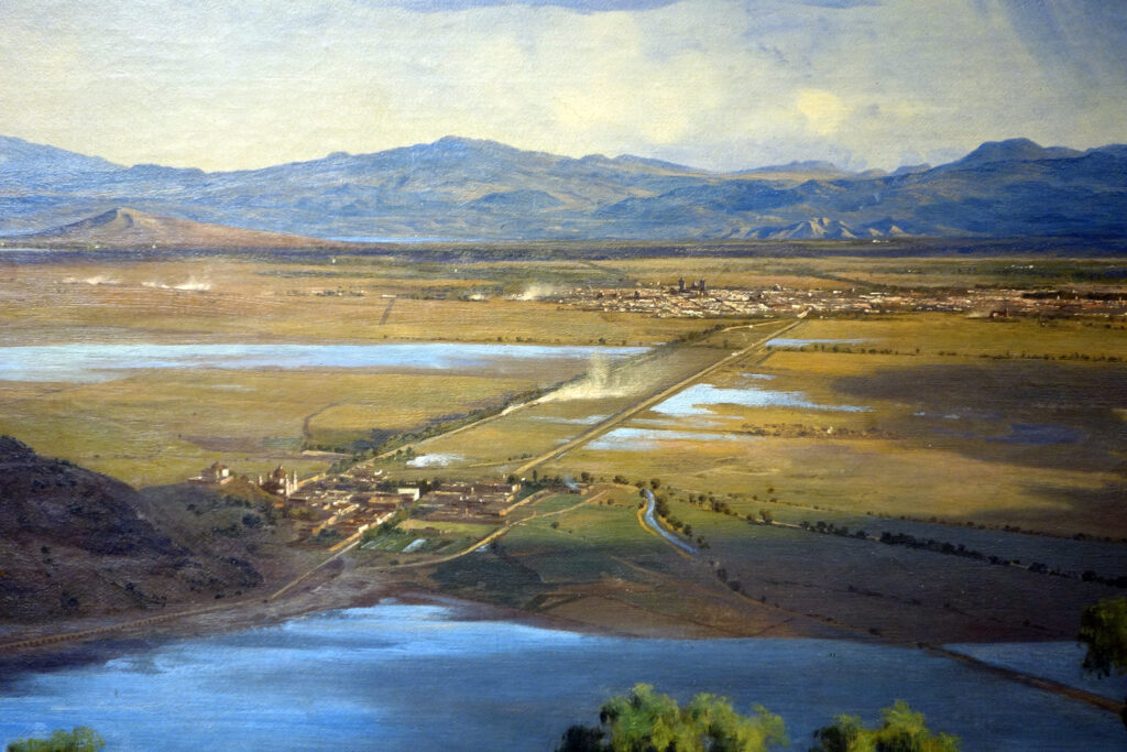 José María Velasco: Detail showing Basilica of Guadalupe (bottom left), edge of Lake Texcoco (in the foreground), and Mexico City (in the background) from José María Velasco, The Valley of Mexico from the Santa Isabel Mountain Range, 1875, Museo Nacional de Arte, Mexico City, Mexico. Photograph by Steven Zucker via SmartHistory (CC BY-NC-SA 2.0).
