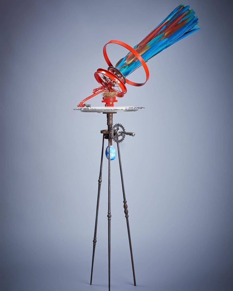 Jasmine Thomas-Girvan: Jasmine Thomas-Girvan, Cosmic Whispers (His Master’s Voice), 2019, bicycle wheel, nest, watch parts, silver tray, etched plexiglass, macaw feathers, bronze, aluminium, steel, painted calabash. Photograph by Michele Jorsling.
