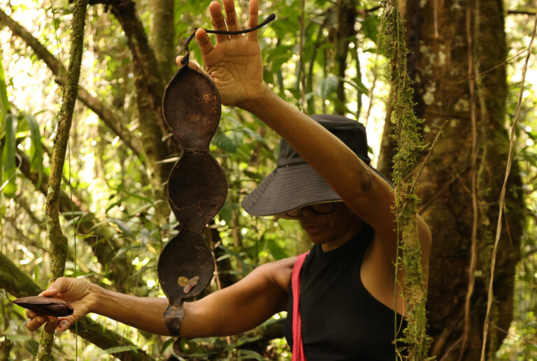 Jasmine Thomas-Girvan: Photograph of Jasmine Thomas-Girvan making a sculpture in a forest, date unknown, Photo Courtesy Rhonda Chan Soo.
