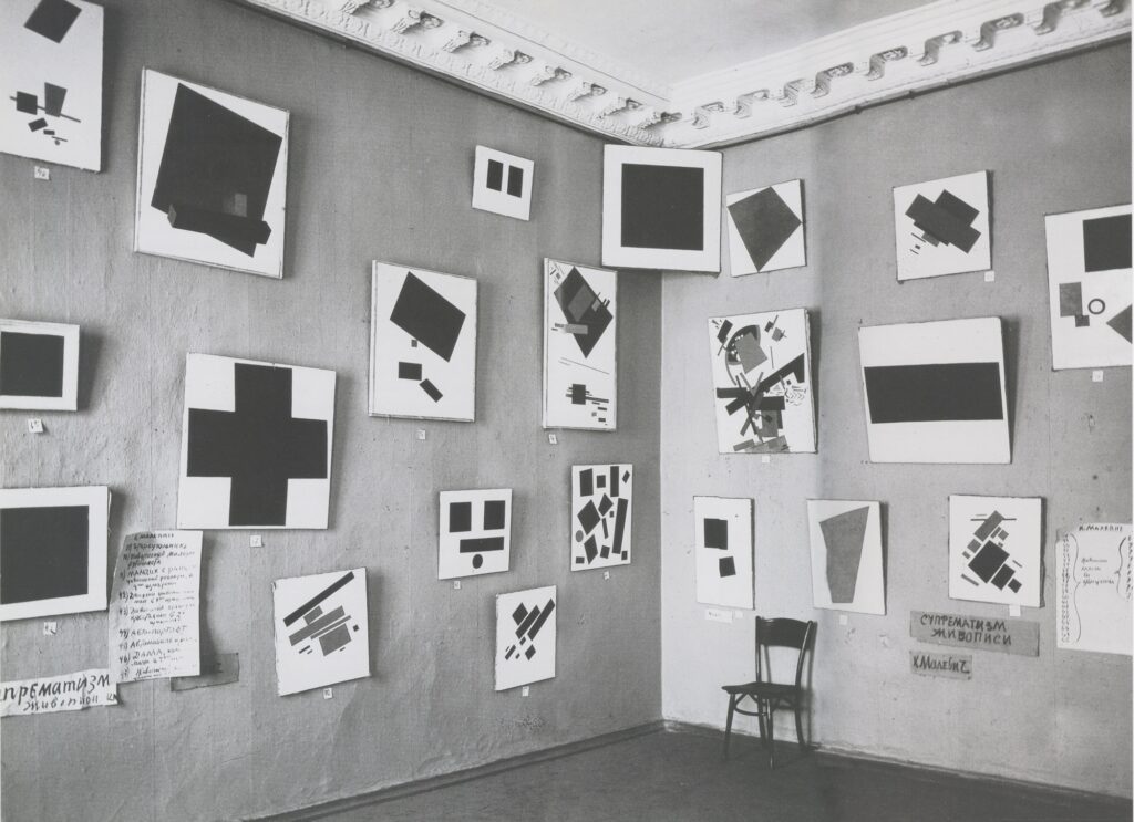 Kandinsky and Malevich: Suprematist works by Malevich (Black Square in the corner) at The Last Futurist Exhibition of Painting 0,10, 1915, St. Petersburg, Russia. Wikimedia Commons (public domain).
