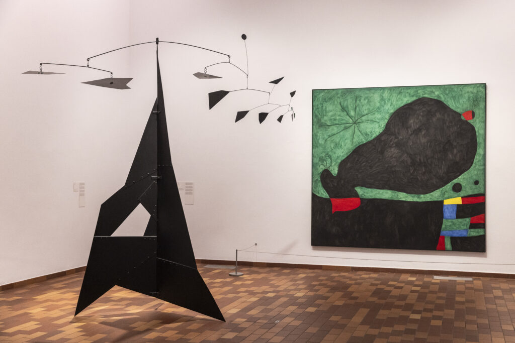 Miró United States: Rooms of the exhibition Miró and the United States. Curators Marko Daniel, Matthew Gale, and Dolors Rodriguez Roig. Artworks (from left to right): Alexander Calder, El Corcovado [The Corcovado], 1951; Joan Miró, Message d’ami (Message from a Friend), 1964. Photo: Davide Camesasca. © Fundació Joan Miró. Press materials.
