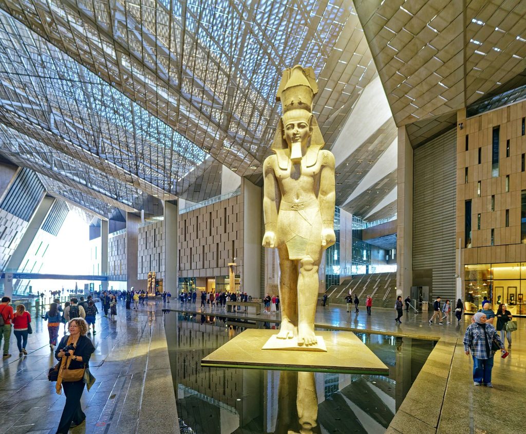 Grand Egyptian Museum: Colossal Statue of Ramesses II inside the Grand Hall, c. 1175 BCE, Grand Egyptian Museum, Cairo, Egypt. Photograph by Richard Mortel via Wikimedia Commons (CC BY 2.0).
