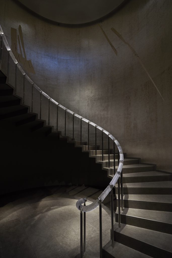 kikuchi biennale: Spiral staircase leading down to the Kikuchi Biennale XI exhibition, Tomo Museum, Tokyo, Japan. Courtesy of Tomo Museum.
