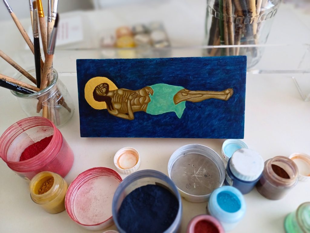 Epitaphios: Traditional workshop scene: hand-grinding natural pigments in the Iconoria studio in Warsaw for the Epitaphios icon. Photograph by the author.
