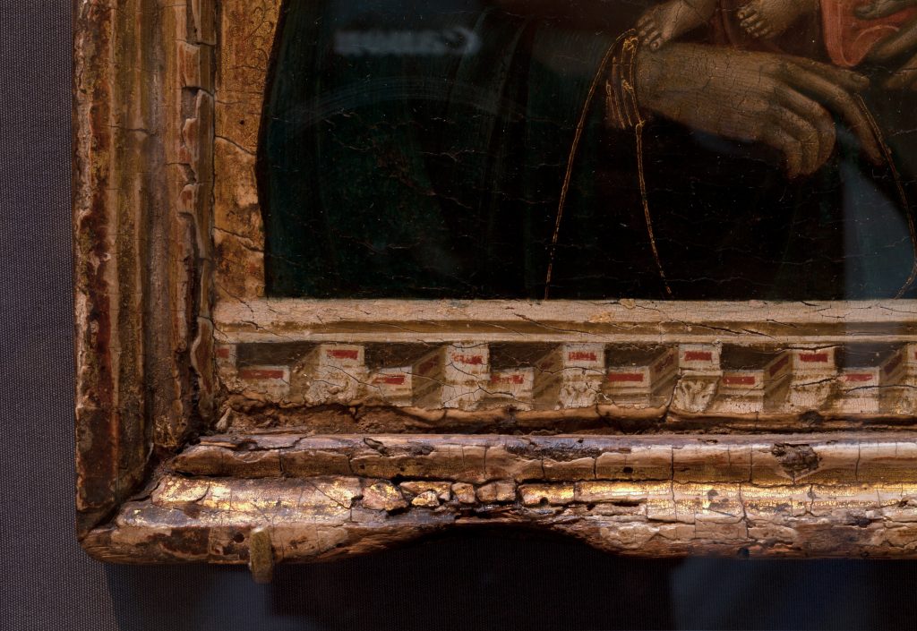 Met famous paintings: Duccio, Madonna and Child, ca. 1290–1300, Metropolitan Museum of Art, New York City, NY, USA. Detail of the 13th-century original frame, rare in any museum; the bottom edge is marked by candle burns.
