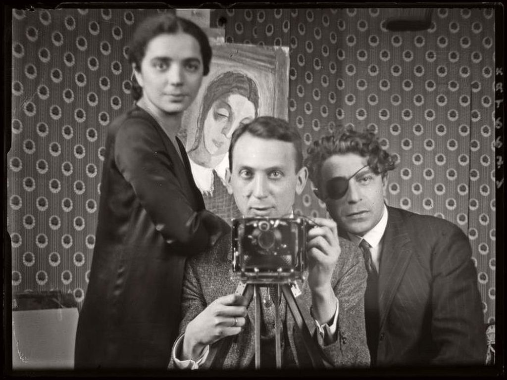 André Kertész: André Kertész, Self-Portrait with Friends, 1926. On this date in photography.
