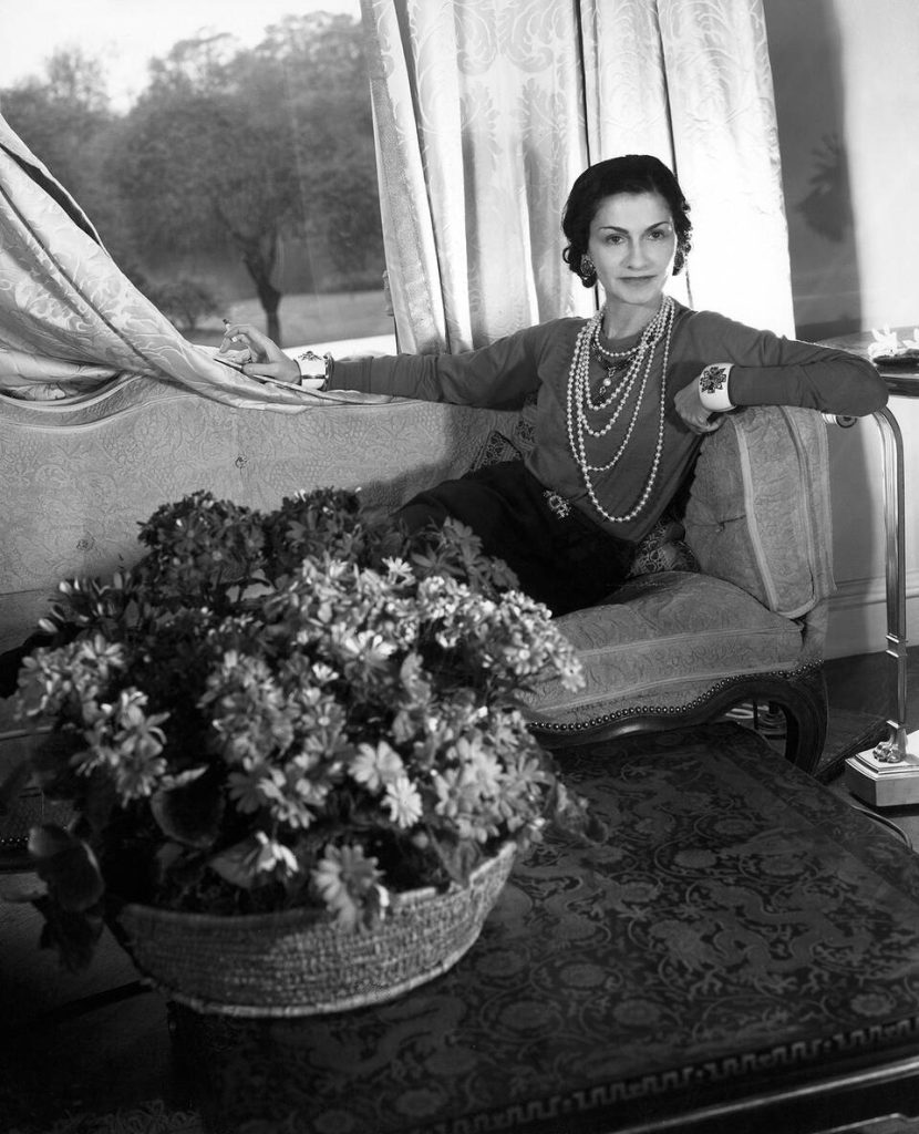 coco chanel designs: Gabrielle “Coco” Chanel wearing a string of pearl necklaces. Photograph by Cecil Beaton, 1937. V&A.
