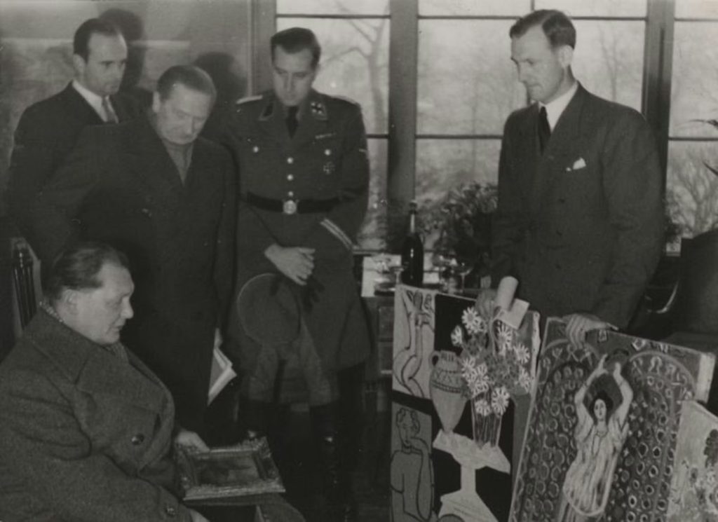 Matisse Chicago: Bruno Lohse holds up two Matisse paintings, including Daisies, for Hermann Göring’s appraisal. Art Institute of Chicago.
