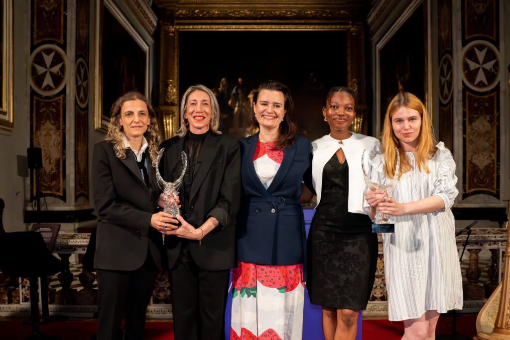 Malta Biennale: Artists presented at the OmenaArt Foundation’s Pavilion: Eliza Proszczuk (in the center), Ernestina Doku, and Marta Nadolle (on the right) with The Maltese Falcon Award. Press materials.
