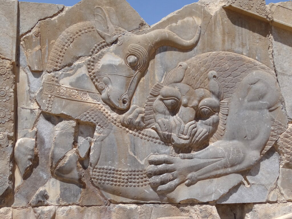 Lion and sun: Lion Attacking Bull, 4th century BCE, Persepolis, Iran. Photograph by Adam Jones via Wikimedia Commons (CC BY-SA 2.0).
