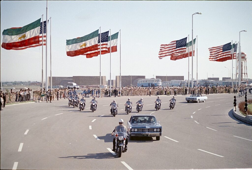 Lion and sun: Motorcade carrying U.S. President Richard Nixon during official visit to Tehran, Iran, May 1972. Wikimedia Commons (public domain).
