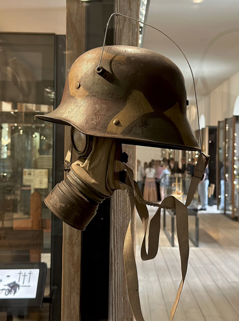 star wars propaganda art: Imperial German Army military steel helmet with camouflage paint and a gas mask used during World War I. Danish War Museum, Copenhagen, Denmark. Photograph by Wolfmann via Wikimedia Commons (CC BY-SA 4.0).

