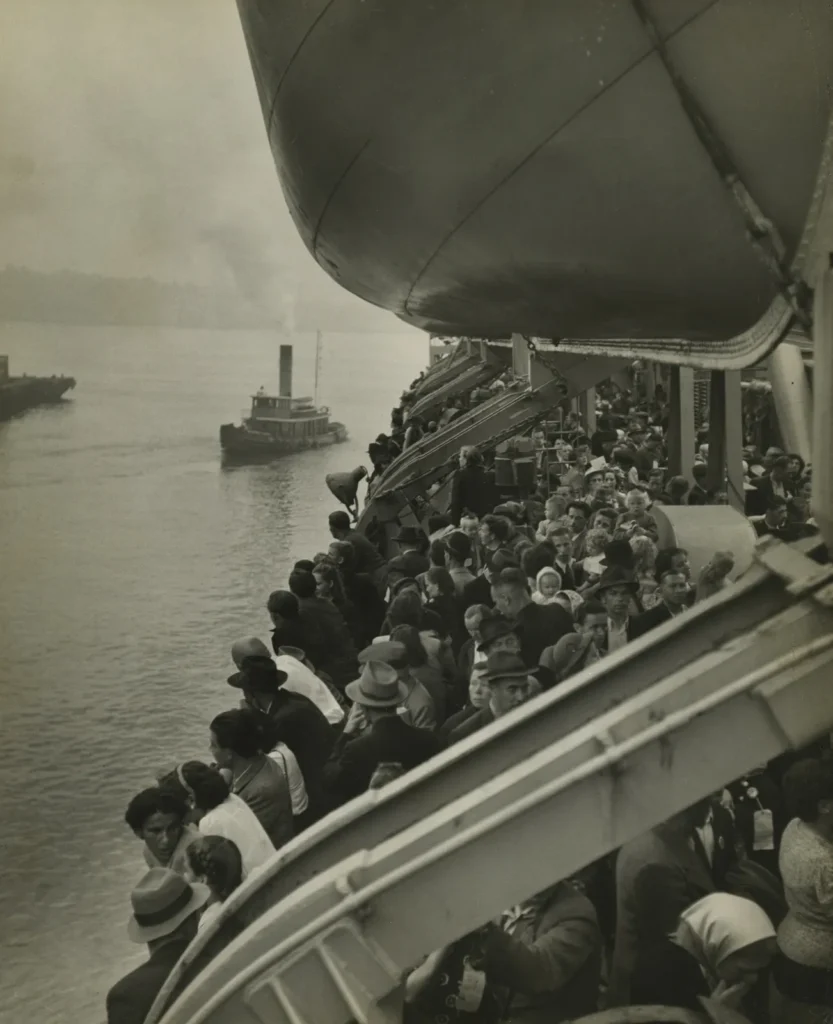 migrant photographs: Ernst Haas, Last Displaced Person Boat (View of Immigrant Ship in New York Harbor, Bound for Ellis Island), 1951, Howard Greenberg Gallery, New York City, NY, USA.
