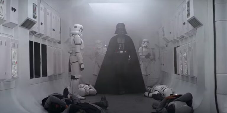 star wars propaganda art: The first ever appearance of Darth Vader on screen in Star Wars: Episode IV—A New Hope, directed by George Lucas, 1977. Screen Rant.
