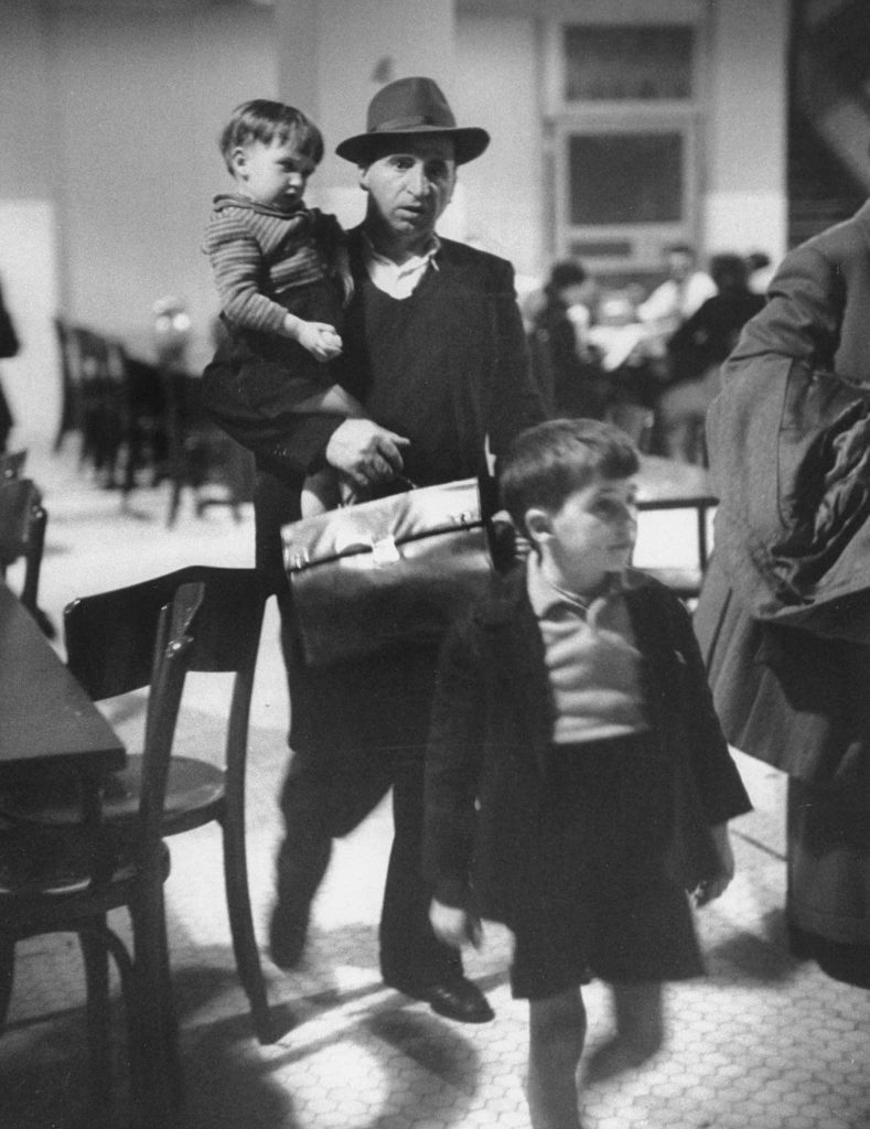 migrant photographs: Alfred Eisenstaedt, Antonio Magnani Coped with His Children and Fat Briefcase Holding His Entry Papers, Ellis Island from Life, November 13, 1950.
