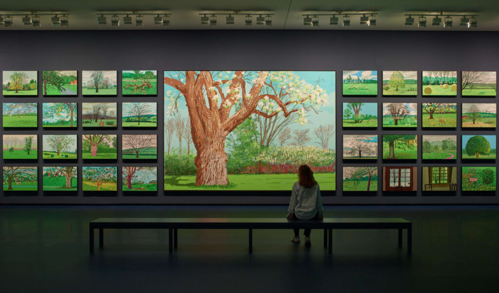David Hockney artworks: David Hockney in 10 Artworks: David Hockney, Arrival of Spring, Normandy, 2020 series, 2020, exhibition view of David Hockney 25, 2025, Louis Vuitton Foundation, Paris, France. Photo: Fondation Louis Vuitton / Marc Domage. Contemporary Lynx.
