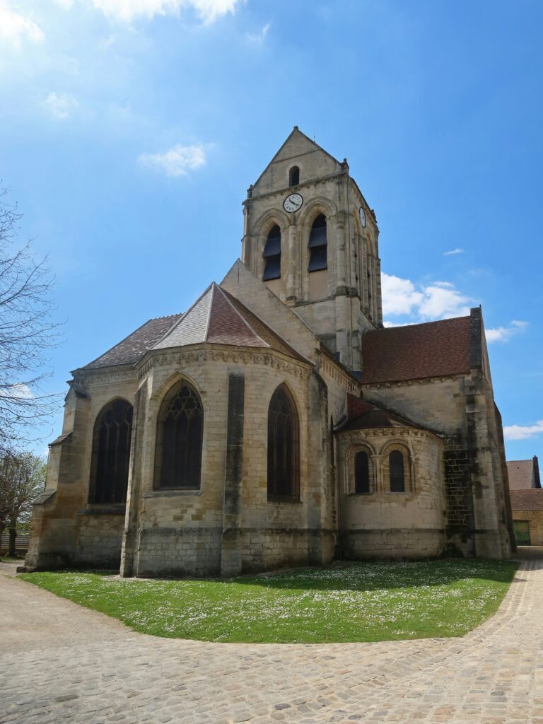 Places from Iconic Paintings: Church Notre-Dame-de-l’Assomption, Auvers-sur-Oise, France. Photograph by Chris Linnett via Unsplash.

